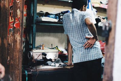 Rear view of man working at market