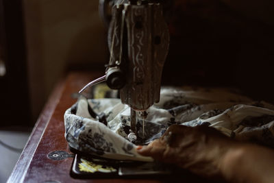 Woman hands working on a old sewing machine