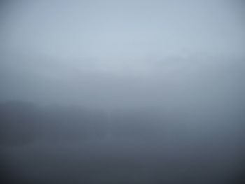 Scenic view of landscape against sky during foggy weather