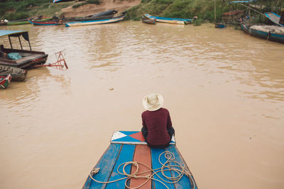 Man sitting on boat in lake