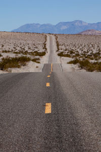 Surface level of road by land against sky