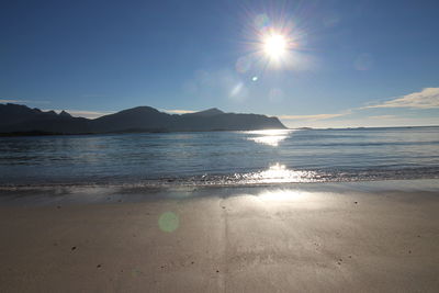 Scenic view of sea against bright sun