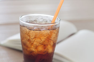 Close-up of drink and book on table