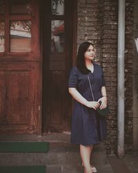 Portrait of a smiling young woman standing outdoors