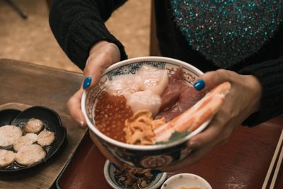 Midsection of woman holding ice cream in bowl