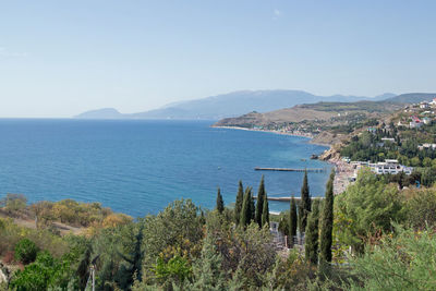 Scenic view of sea by city against sky