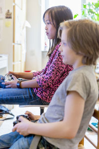 Boy and girl playing video game