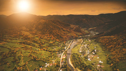 High angle view of road amidst landscape against sky during sunset