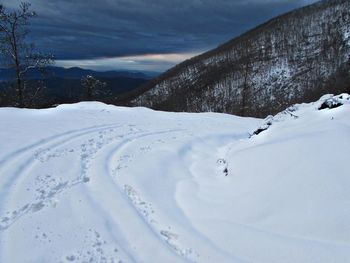 Scenic view of snow covered mountains against sky