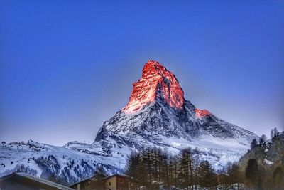 Low angle view of mountain range against clear sky