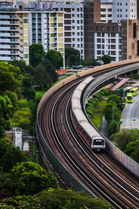 High angle view of railroad tracks by road in city