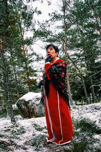 Young woman standing on snow covered land