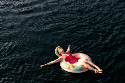 High angle view of woman swimming in sea