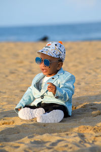 Portrait of boy sitting at beach