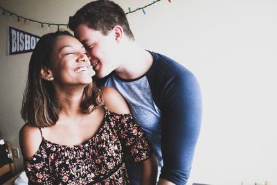 Portrait of young couple kissing outdoors