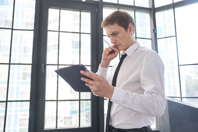 Side view of businessman using mobile phone