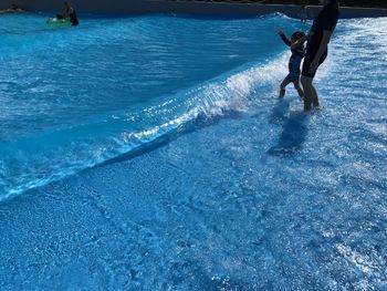 Man surfing in swimming pool