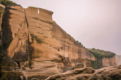 Low angle view of rock formation against clear sky