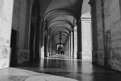 Man walking in corridor of building