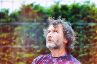 Portrait of man looking away outdoors