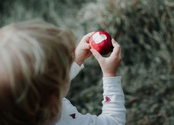 Close-up of boy holding apple