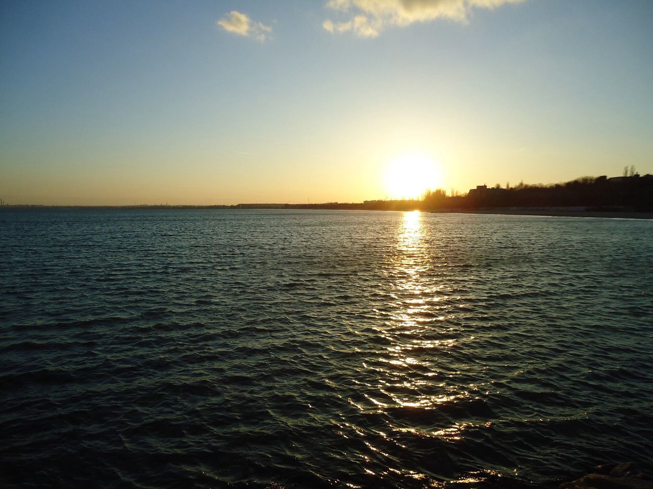 water, sunset, sea, sun, scenics, tranquil scene, waterfront, beauty in nature, tranquility, rippled, reflection, nature, idyllic, sky, horizon over water, sunlight, orange color, seascape, outdoors, sunbeam, no people, remote, calm, non-urban scene, ocean, majestic, blue, water surface