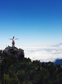 Rear view of man standing on cliff