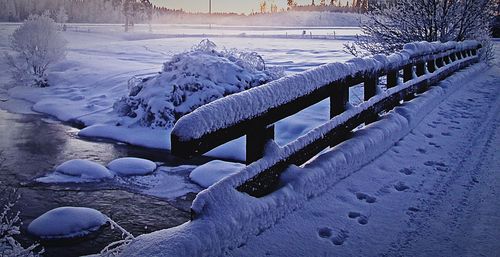 Frozen lake against sky during winter
