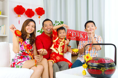 Portrait of happy family enjoying at home during festival