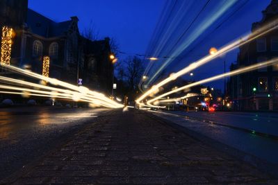 Illuminated light trails on road in city at night