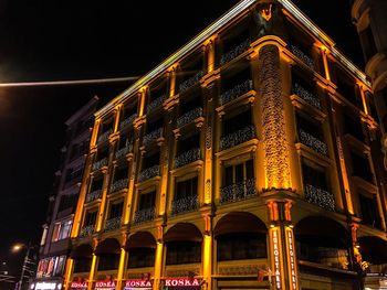 Low angle view of illuminated building at night