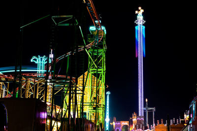 Low angle view of illuminated ferris wheel at night