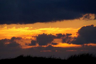 Scenic view of dramatic sky at sunset