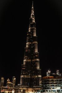 Low angle view of illuminated tower at night