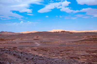 Scenic view of desert against blue sky