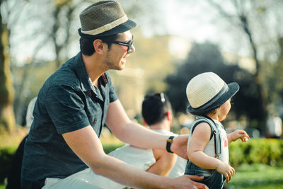 Side view of man wearing hat