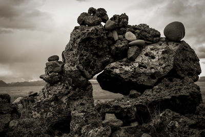 Sculpture in rock against sky