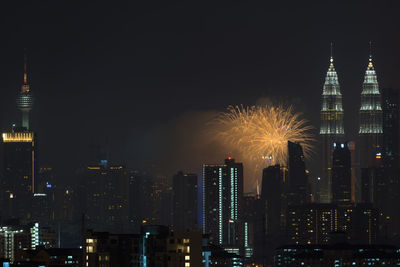 Firework display over city at night