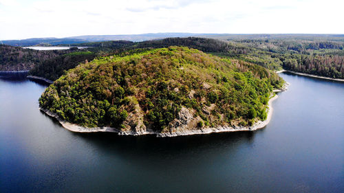 High angle view of river amidst trees against sky