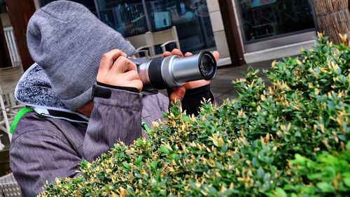 Close-up of man photographing flowers
