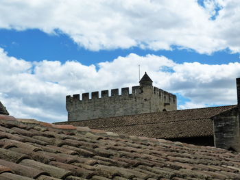 Low angle view of historic building against cloudy sky