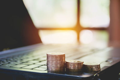 Close-up of coins on laptop over table