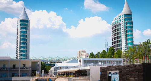 Buildings against cloudy sky