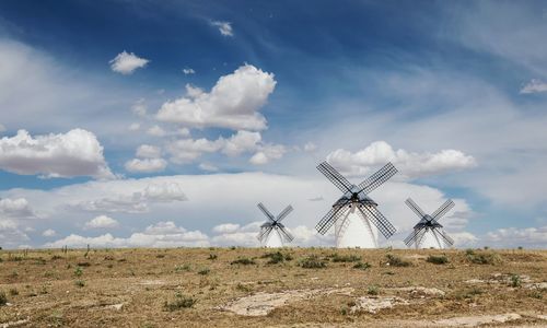 Traditional windmill on field against sky