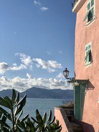 Scenic view of sea and buildings against sky