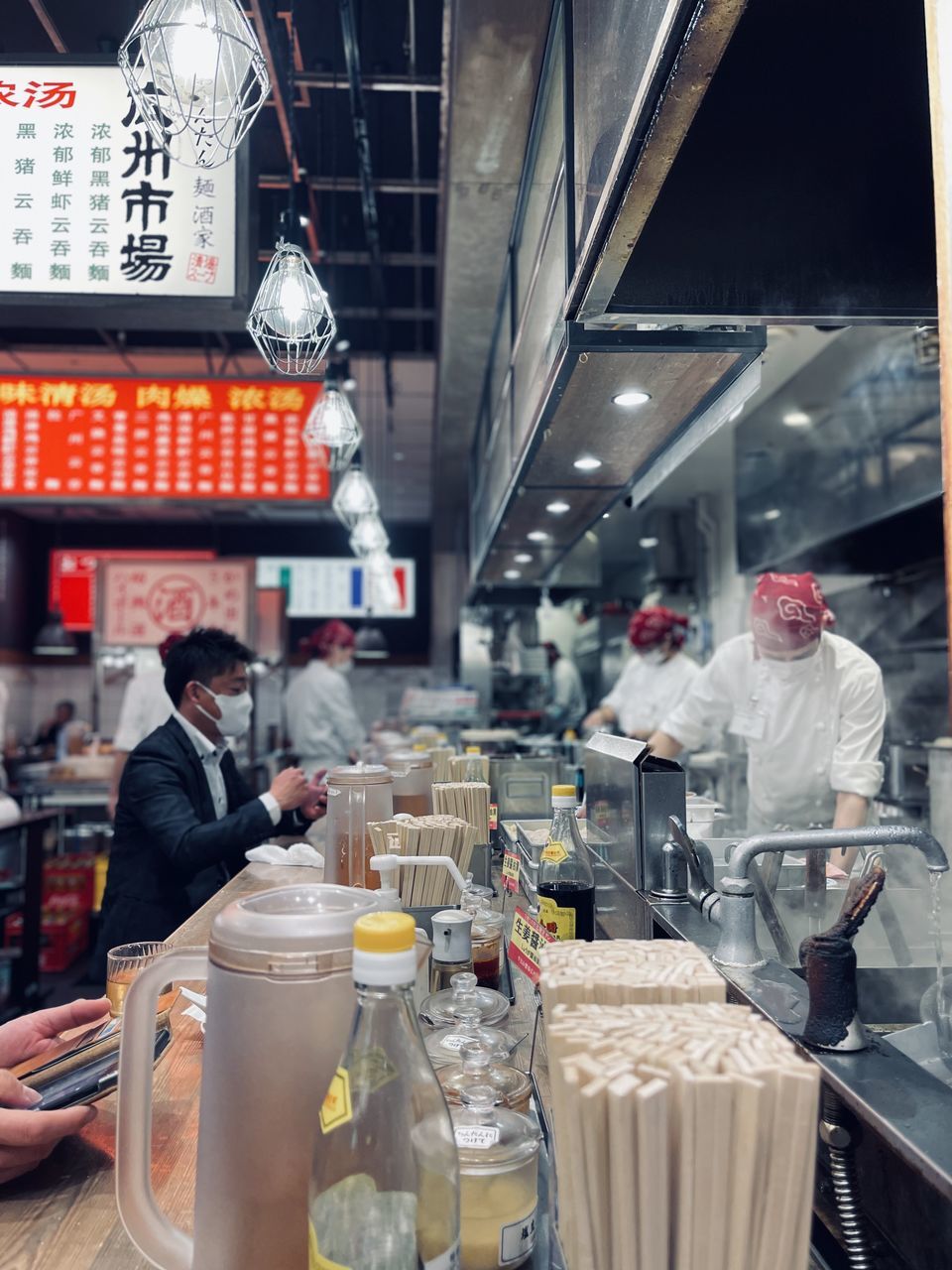 Business Food And Drink Adult Food Men Architecture Occupation City Group Of People Restaurant Working Retail  Business Finance And Industry person Clothing Container Indoors  Market Communication Standing