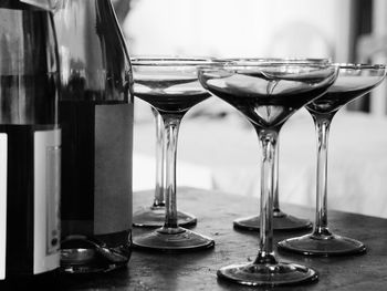 Close-up of wine glasses and wine bottles on table