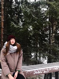 Young woman standing in park during winter