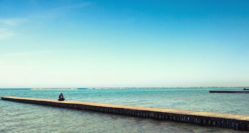 Scenic view of sea against clear blue sky