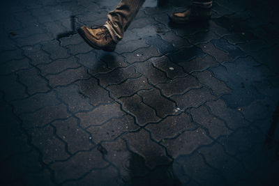 Low section of person standing on footpath